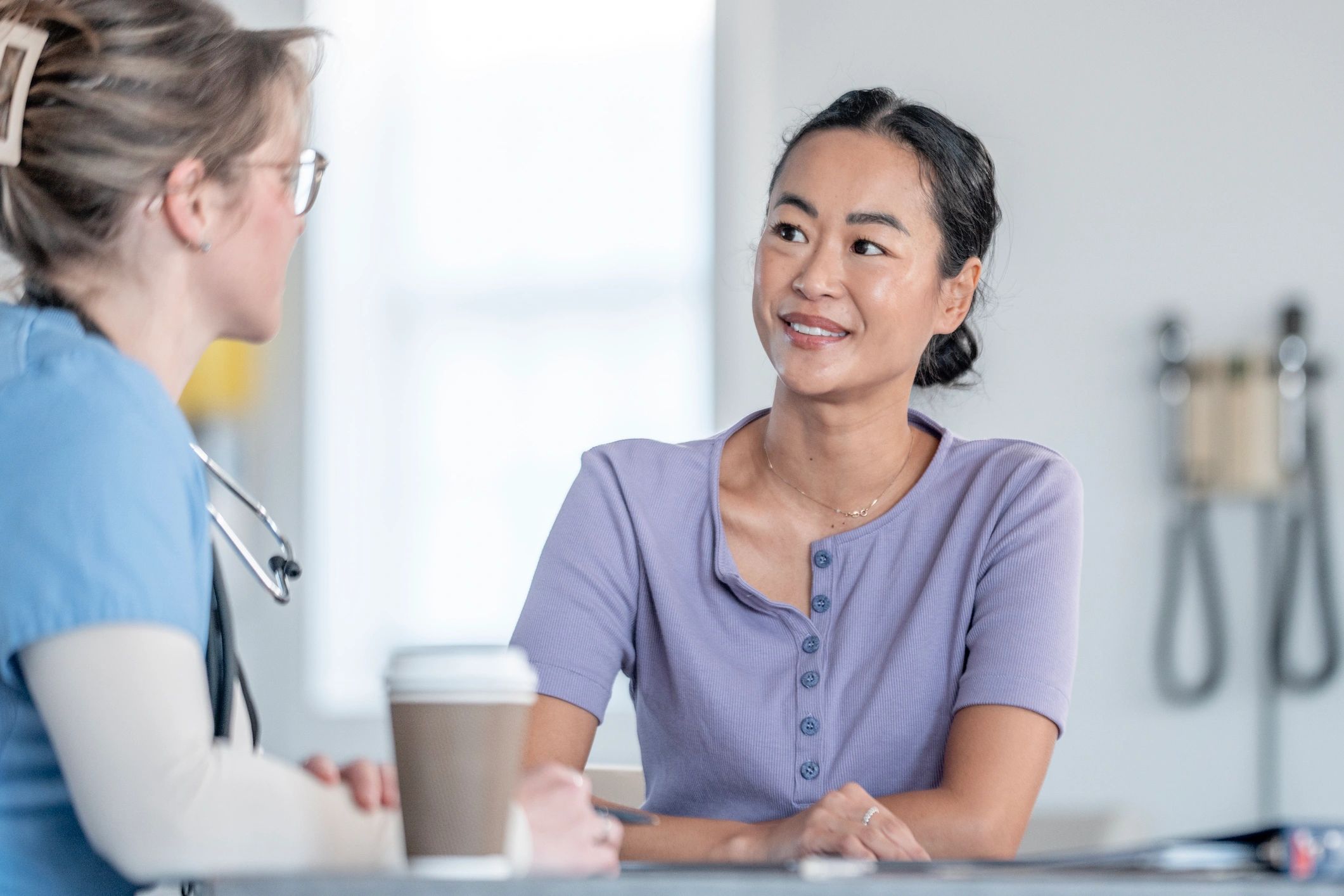 Adult patient speaking with a clinician during a calm consultation