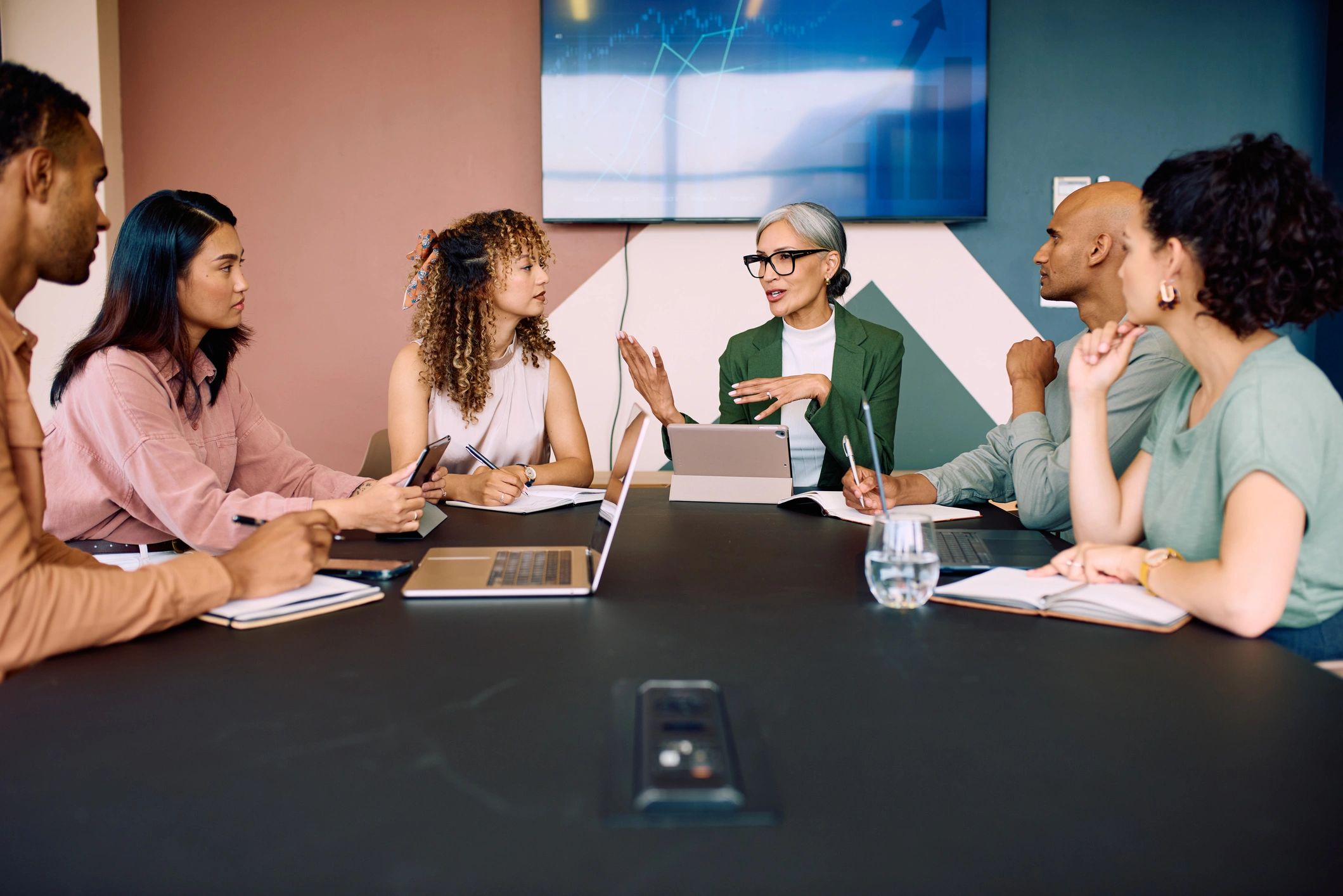 Professionals collaborating around a boardroom table
