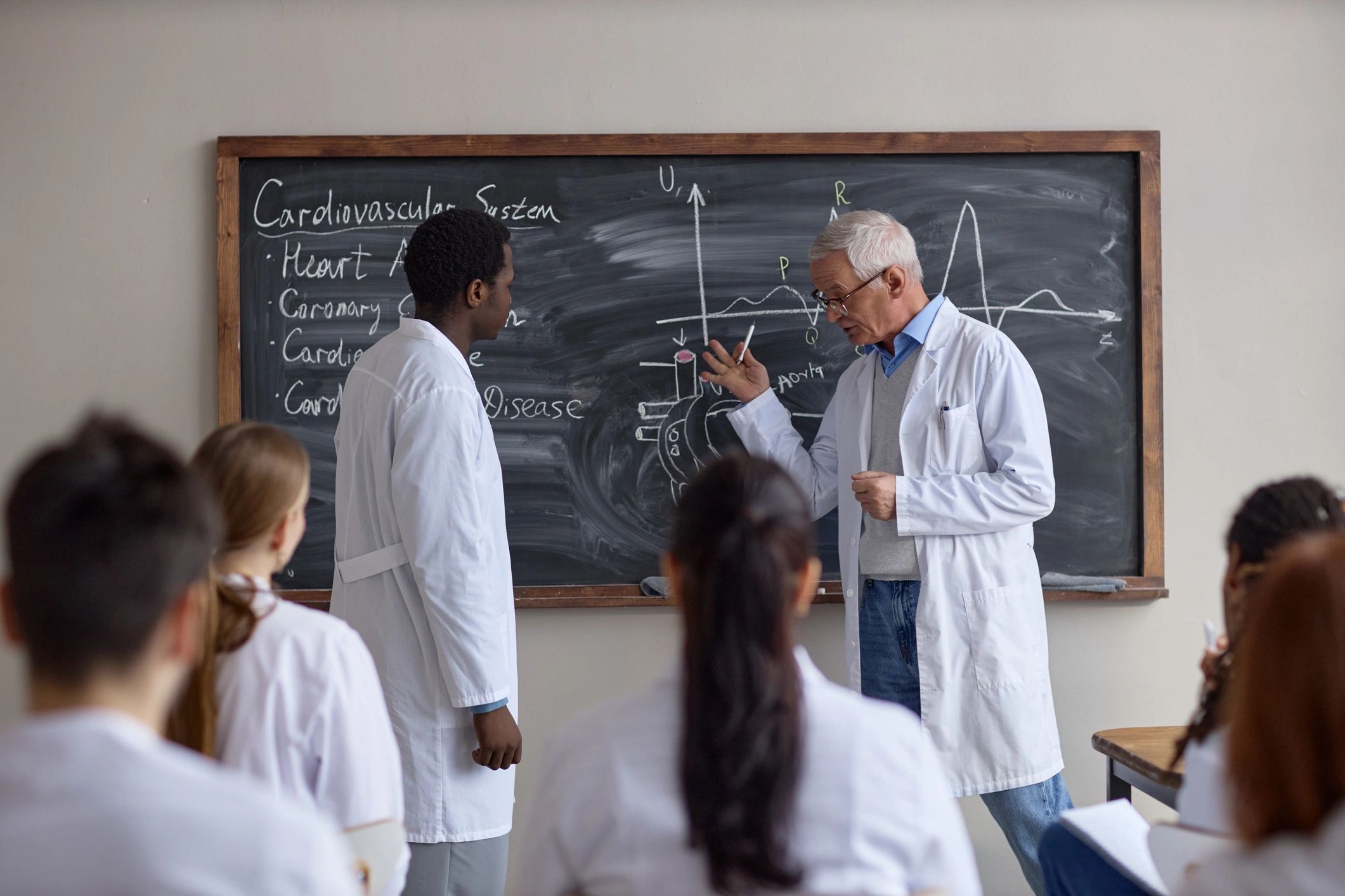 Senior doctor teaching medical students during a classroom lecture